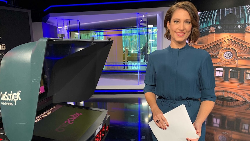 Tamara Oudyn stands next to the auto cue in a television studio.