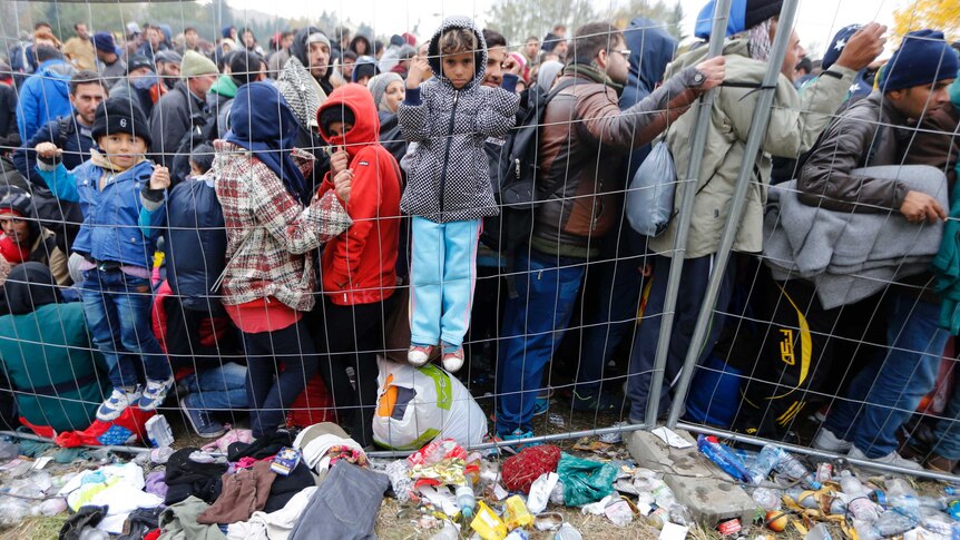 Children asylum seekers against fence