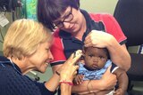 RFDS doctor examines a baby