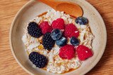 Bowl of overnight oats with chia seeds, topped with berries, an easy breakfast recipe.