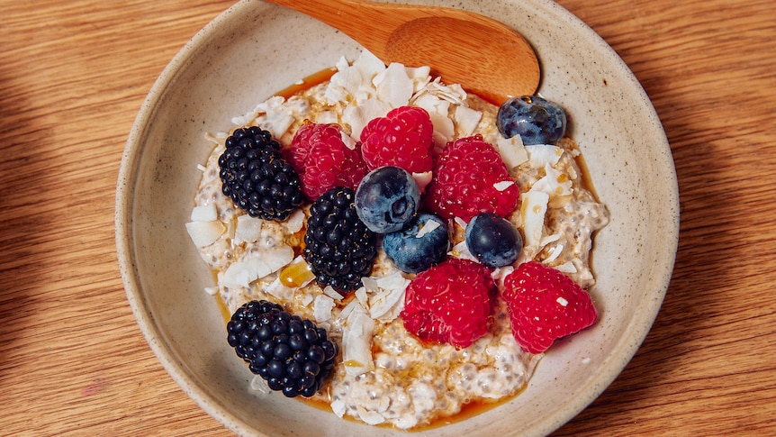 Bowl of overnight oats with chia seeds, topped with berries, an easy breakfast recipe.
