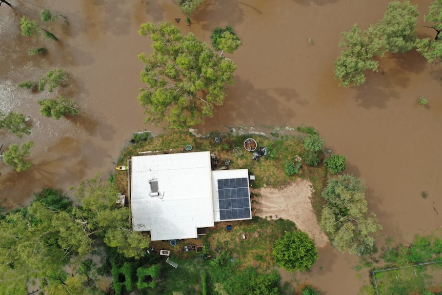 A drone picture of a home about the be flooded. 