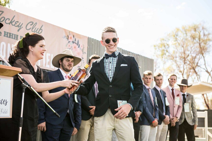 Boyd Williams accepting a fashions win at the Alpha 2018 Races