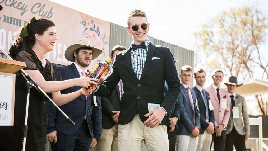 Boyd Williams accepting a fashions win at the Alpha 2018 Races