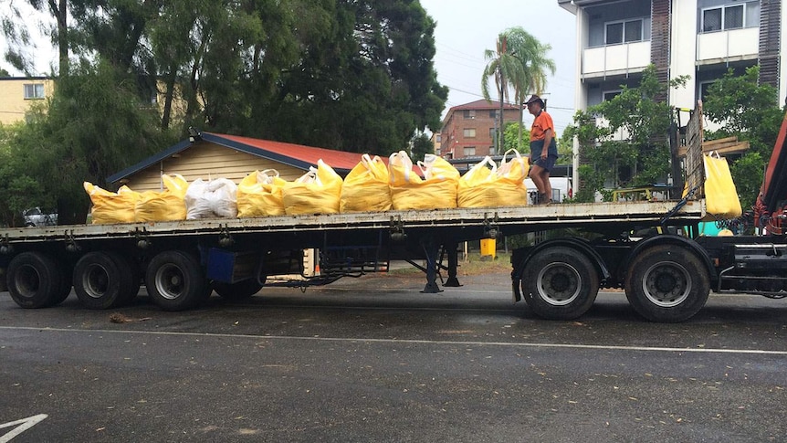 Thousands of sandbags have been filled across Brisbane in preparation for heavy rain and king tides.