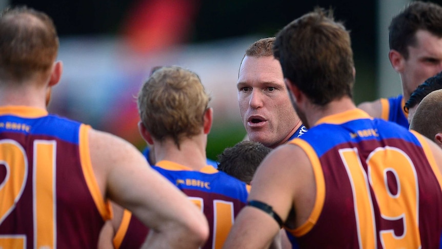 Laying down the law ... Lions coach Justin Leppitsch talks to his players at three-quarter time