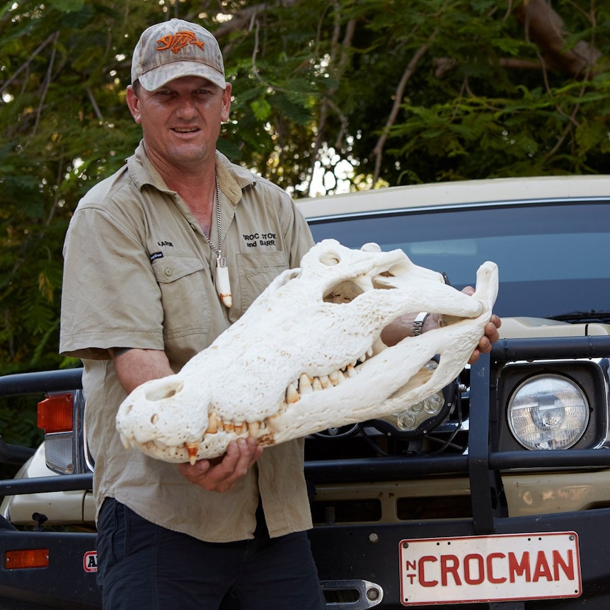 Aaron Rodwell from Croc Stock and Barra holding a large crocodile skull