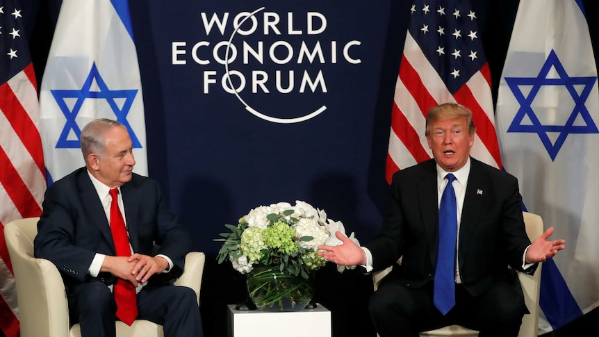 US President Donald Trump, right, sits next to Israeli Prime Minister Benjamin Netanyahu at the World Economic Forum.