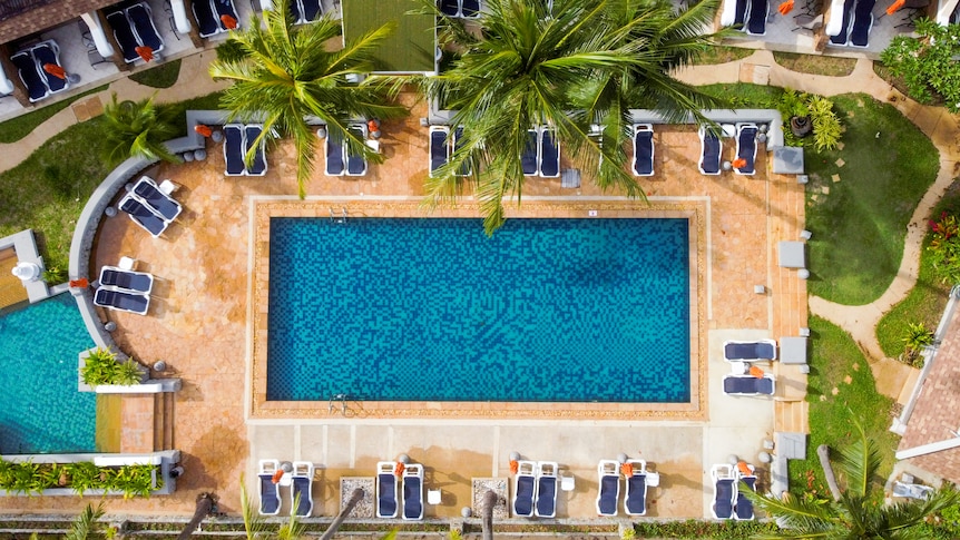 A drone shot of an empty pool at a hotel 