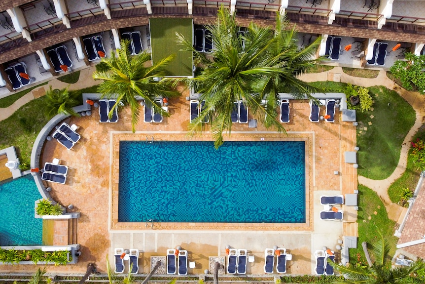 A drone shot of an empty pool at a hotel 