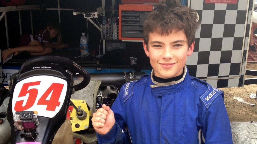 Calan Williams as a young boy standing next to his racing go kart.