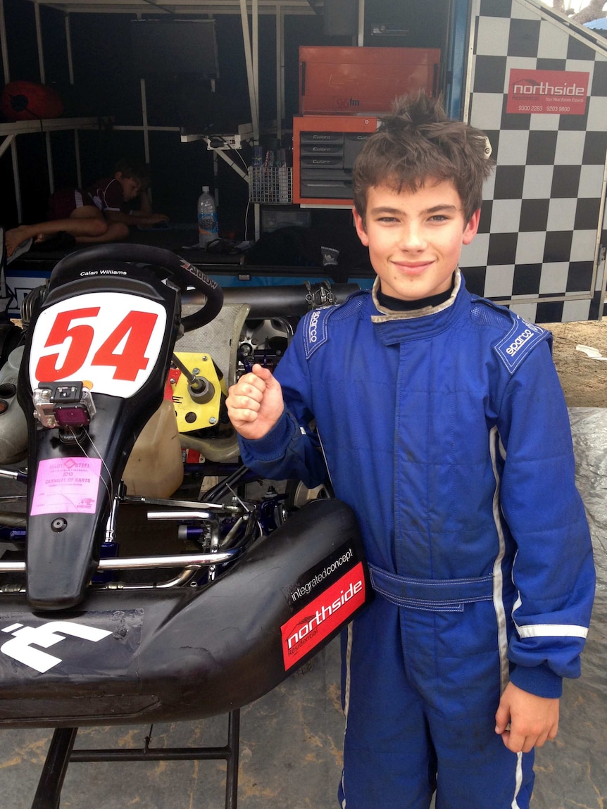 Calan Williams as a young boy standing next to his racing go kart.