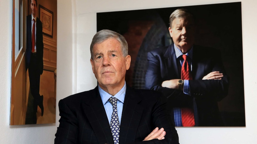 David Leckie stands in front of his portrait at Sydney's Machiavelli restaurant.