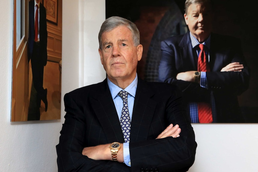David Leckie stands in front of his portrait at Machiavelli's restaurant in Sydney.