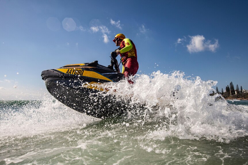 Jet ski with rider onboard riding the waves 