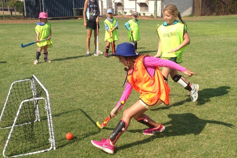 Learning hockey at Sports for Bush Kids camp