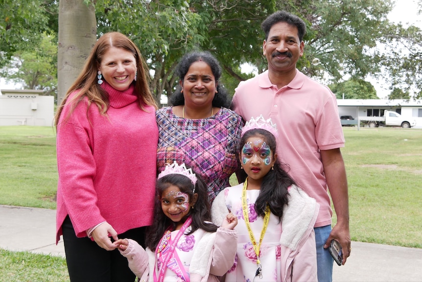 A woman stands with the Biloela Tamil asylum seeker family