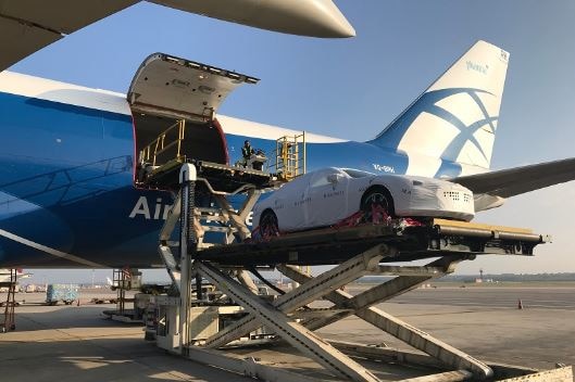 A car is being unloaded from a plane.