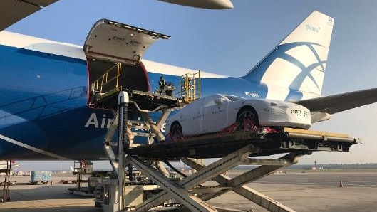 A car is being unloaded from a plane.