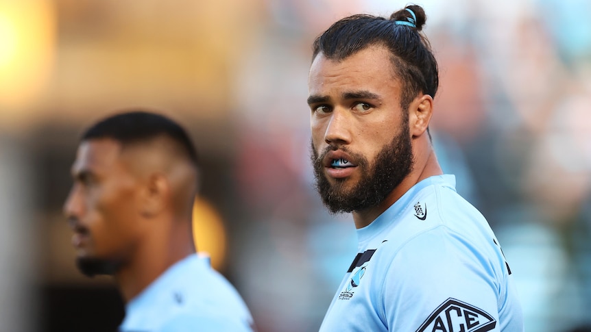 A Cronulla NRL player looks to his left as he warms up for an NRL match in the 2023 season.