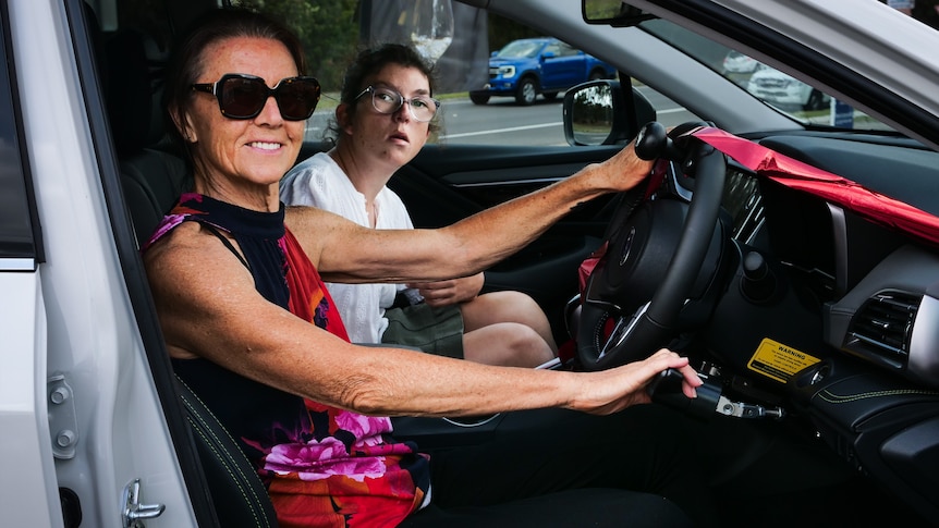 A mum and her daughter in a new car.