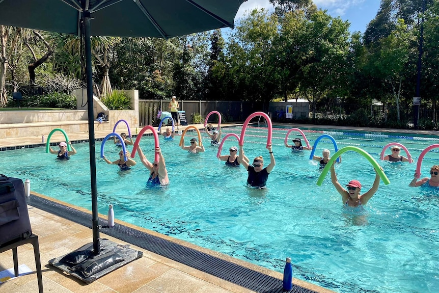 Residents participate in aquarobics class at the Rec Club swimming pool