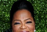 Oprah Winfrey smiles broadly on the red carpet