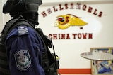 A NSW police officer from Strike Force Raptor, during a raid on the Hells Angels bikie clubhouse at Chinatown in Sydney, 1 August 2013.