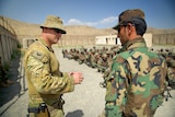 Digger in uniform speaks to Afghan officer
