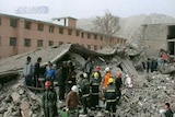 Rescue workers search for quake survivors