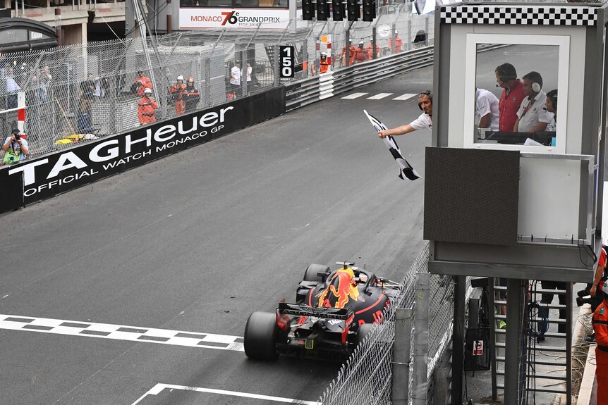 Red Bull driver Daniel Ricciardo crosses the finish line to win the Monaco F1 Grand Prix.