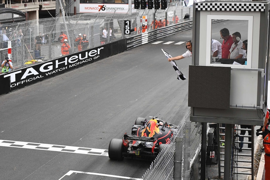Red Bull driver Daniel Ricciardo crosses the finish line to win 2018 Monaco Formula One Grand Prix.