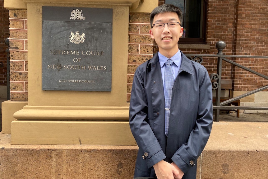 A young Chinese man next to NSW Court. 