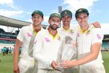Josh Hazlewood, Nathan Lyon, Mitchell Starc and Pat Cummins hold the crystal Ashes trophy after the fifth Test in Sydney.