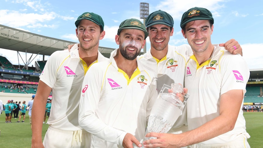 Josh Hazlewood, Nathan Lyon, Mitchell Starc and Pat Cummins hold the crystal Ashes trophy after the fifth Test in Sydney.
