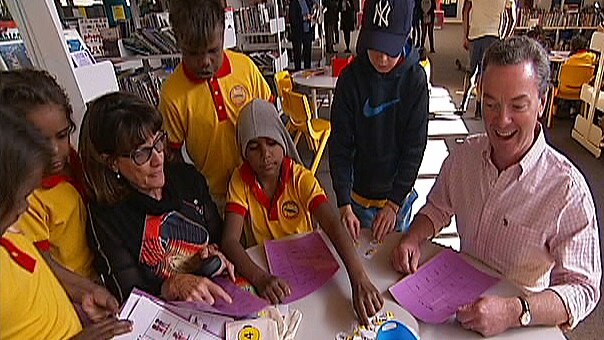 Federal Education Minister Christopher Pyne sits at a table with students from the Yipirinya School in Alice Springs