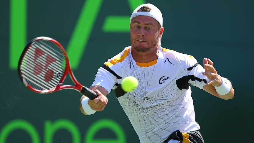 Hewitt stretches for a forehand