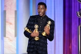 Jerrod Carmichael holding three Golden Globes during the 80th Annual Golden Globe Awards at the Beverly Hilton Hotel.
