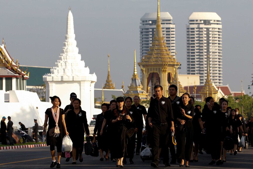 Mourners walk in line as they arrive to attend the Royal Cremation ceremony of Thailand's late King Bhumibol.
