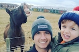 David Bellis and young son Jacob smile next to a "grinning" horse.