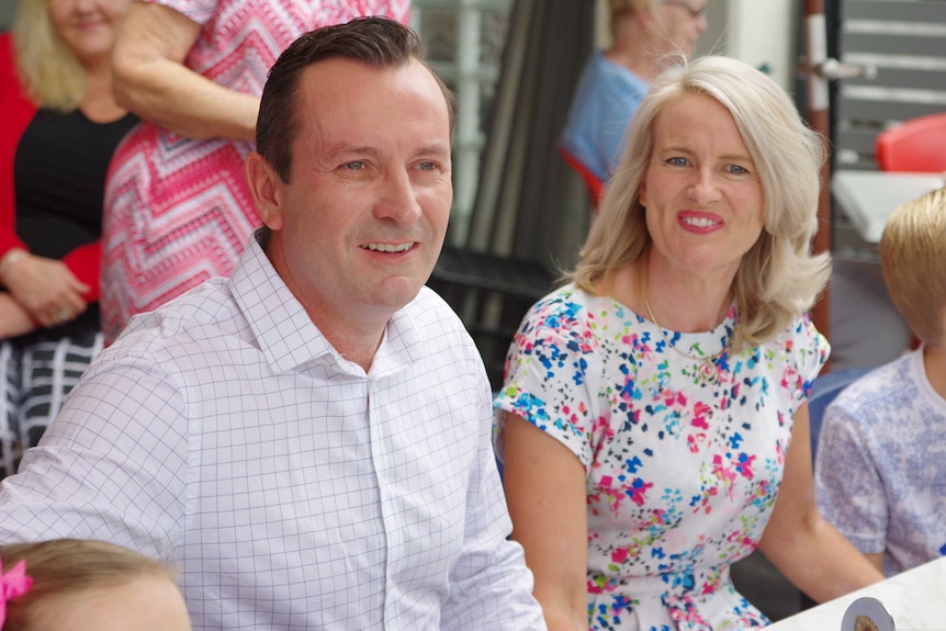 Mark McGowan smiles while sitting next to his wife Sarah.