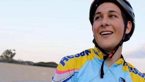 Teenage girl smiles while wearing cycling clothing