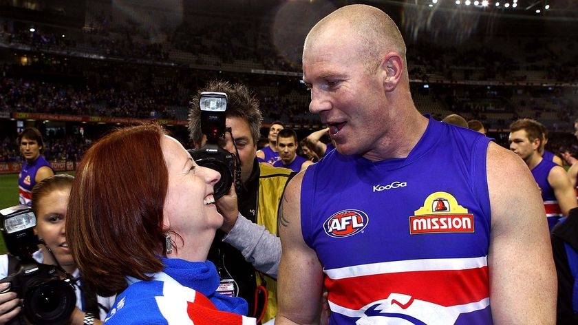 LtoR Prime Minister Julia Gillard celebrates with Western Bulldogs full forward Barry Hall