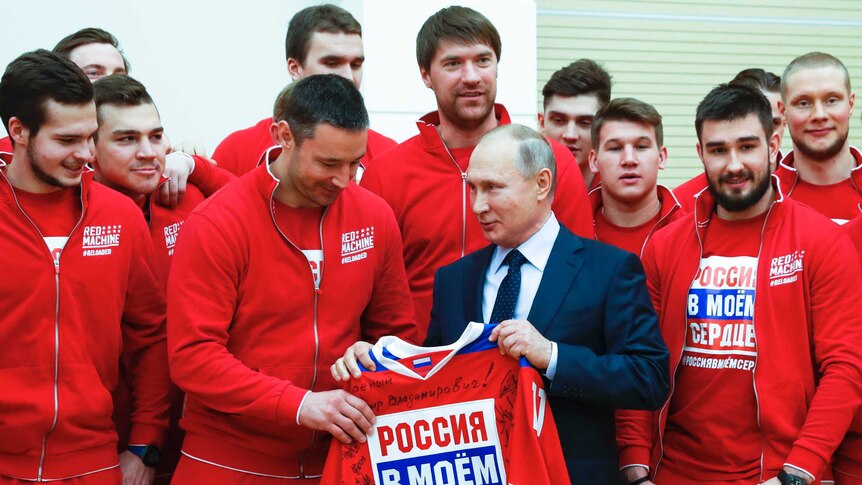 Russian President Vladimir Putin (centre R) meets Russian ice hockey players outside Moscow.