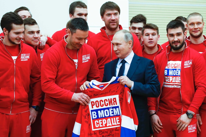 Russian President Vladimir Putin (centre R) meets Russian ice hockey players outside Moscow.