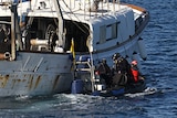 Spanish fishing inspectors prepare to board a suspected illegal trawling boat.