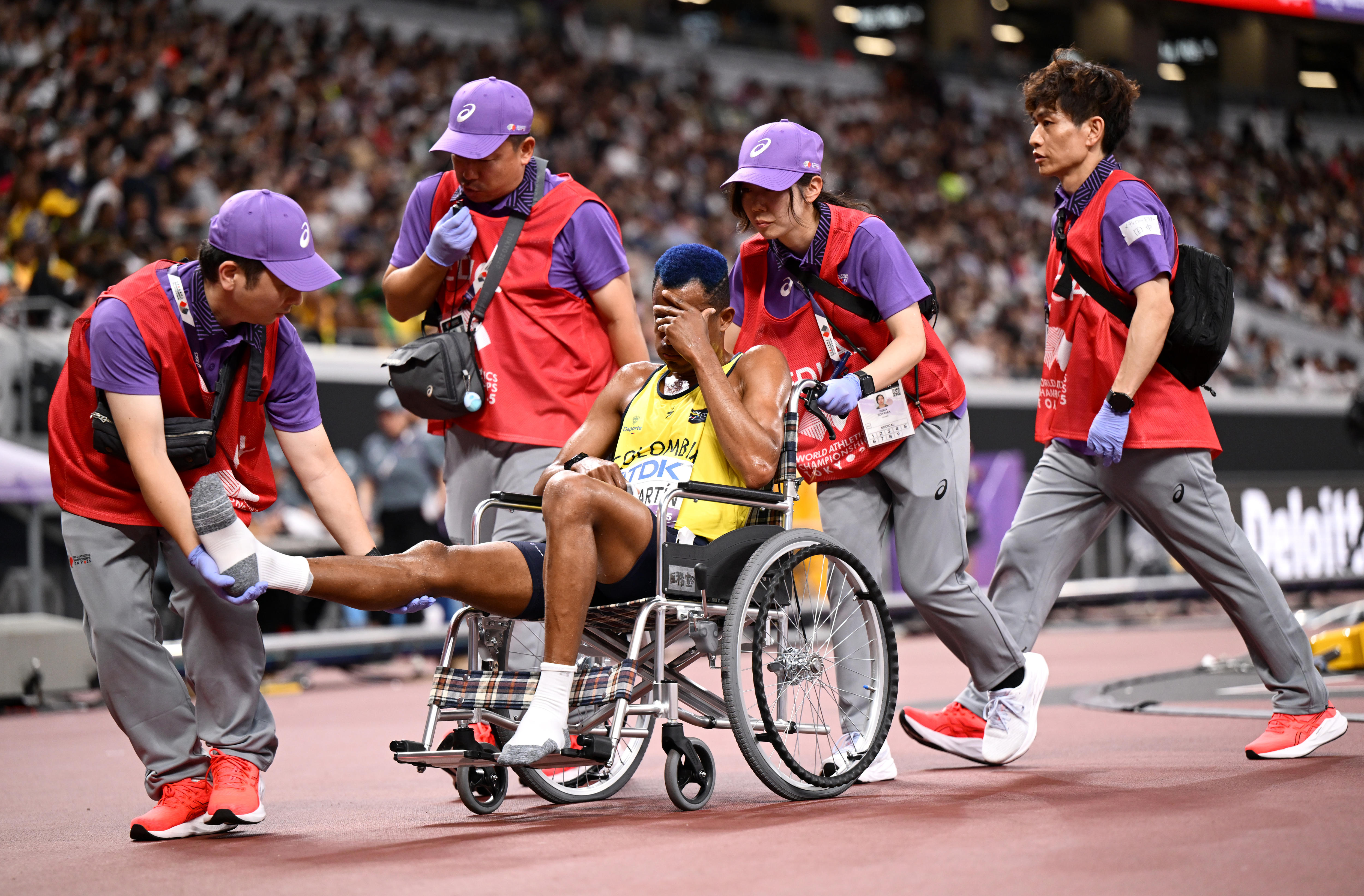 Carlos San Martin being assisted off the track.
