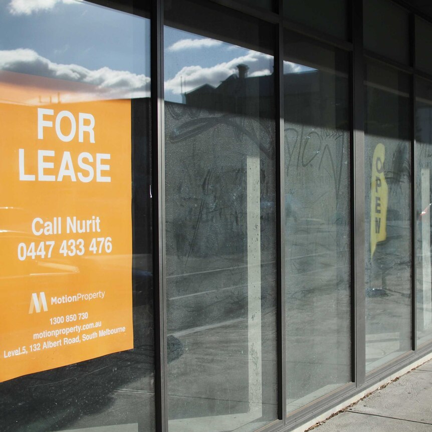Vacant shop with a 'for lease' sign
