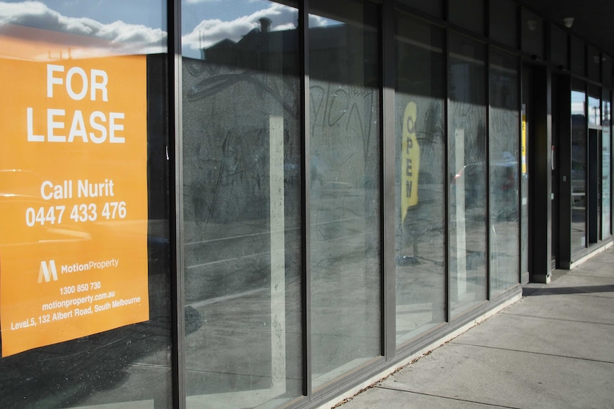 Vacant shop with a 'for lease' sign