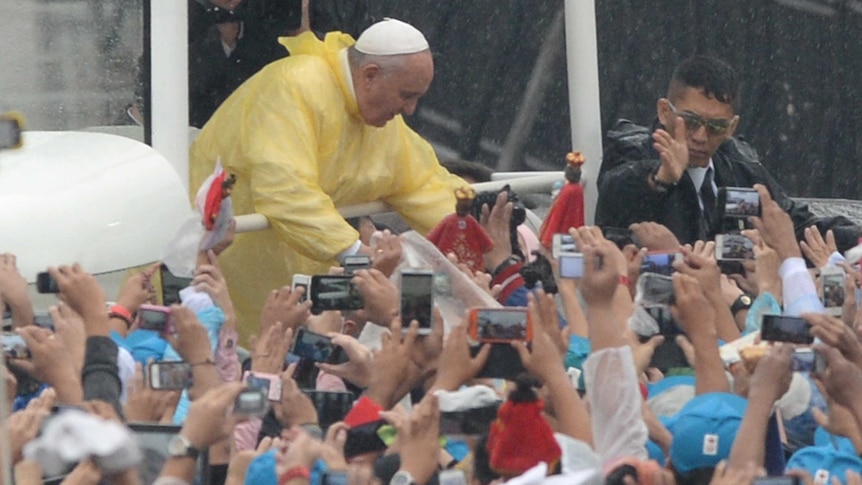 Pope Francis arrives to celebrate a mass at a park in Manila